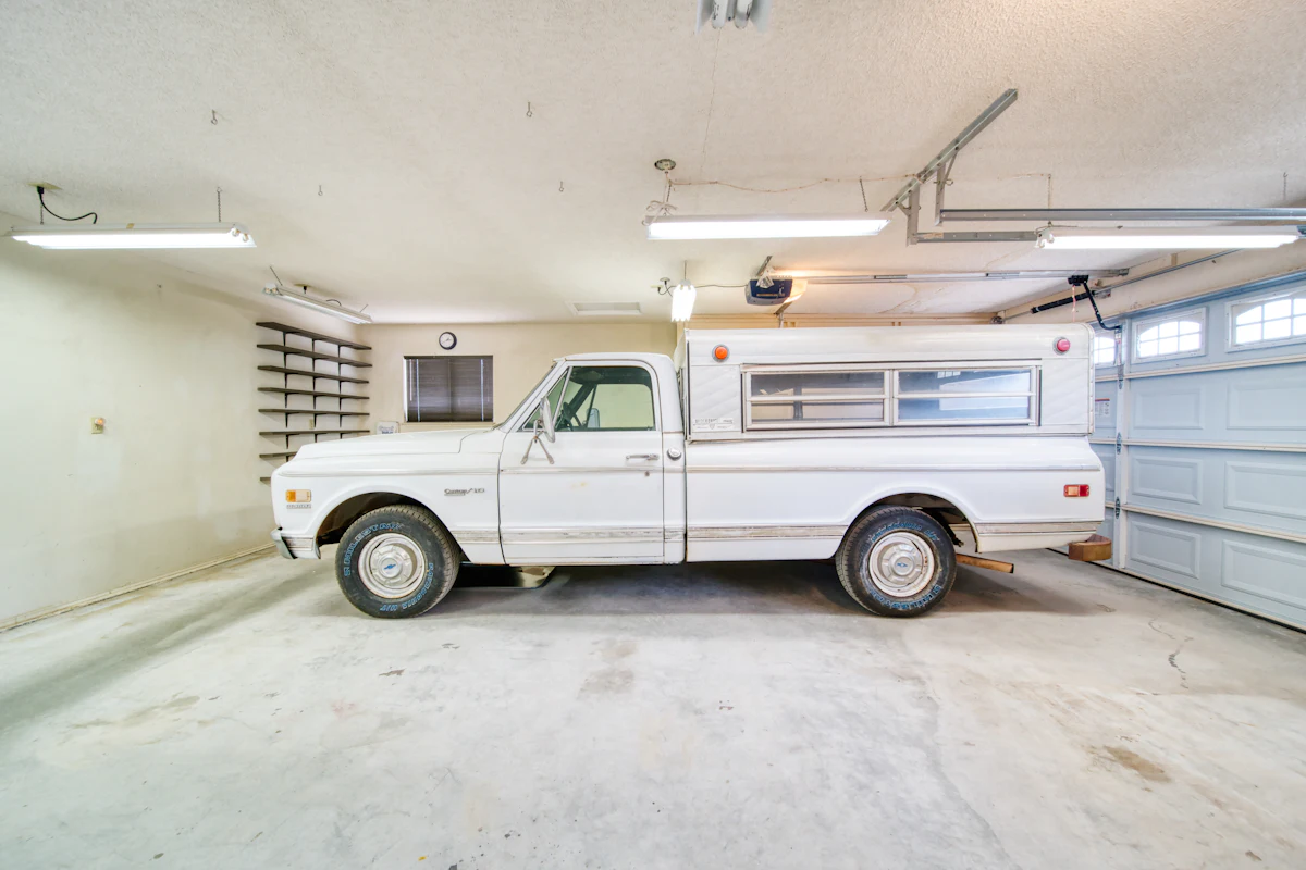 Clean two-car garage with the garage door opener rail on the ceiling